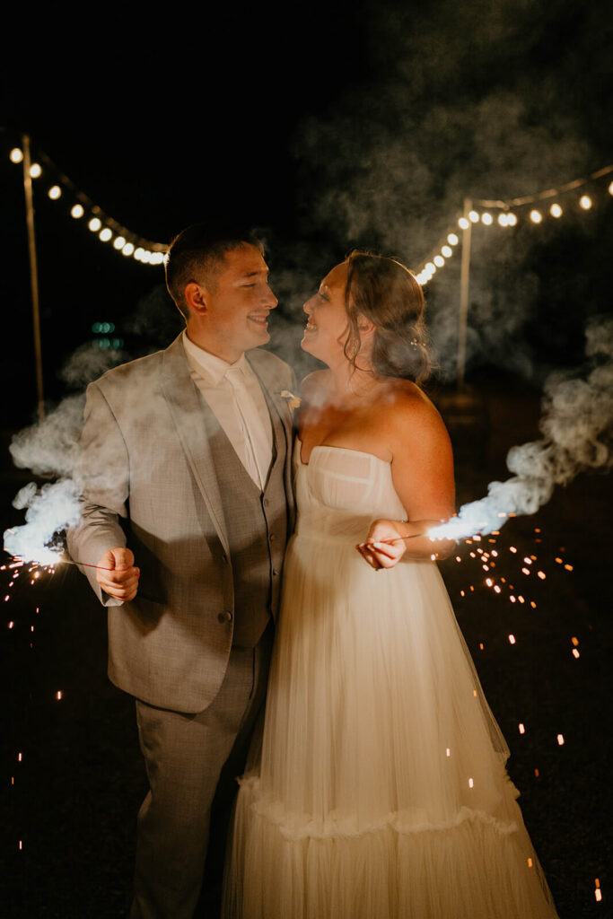 Bride and groom holding sparklers at the end of their wedding in Washington