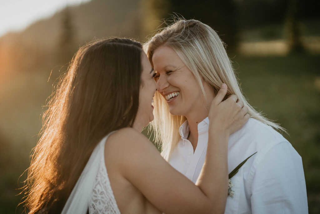 Two brides laughing during Sunrise, Mount Rainier elopement
