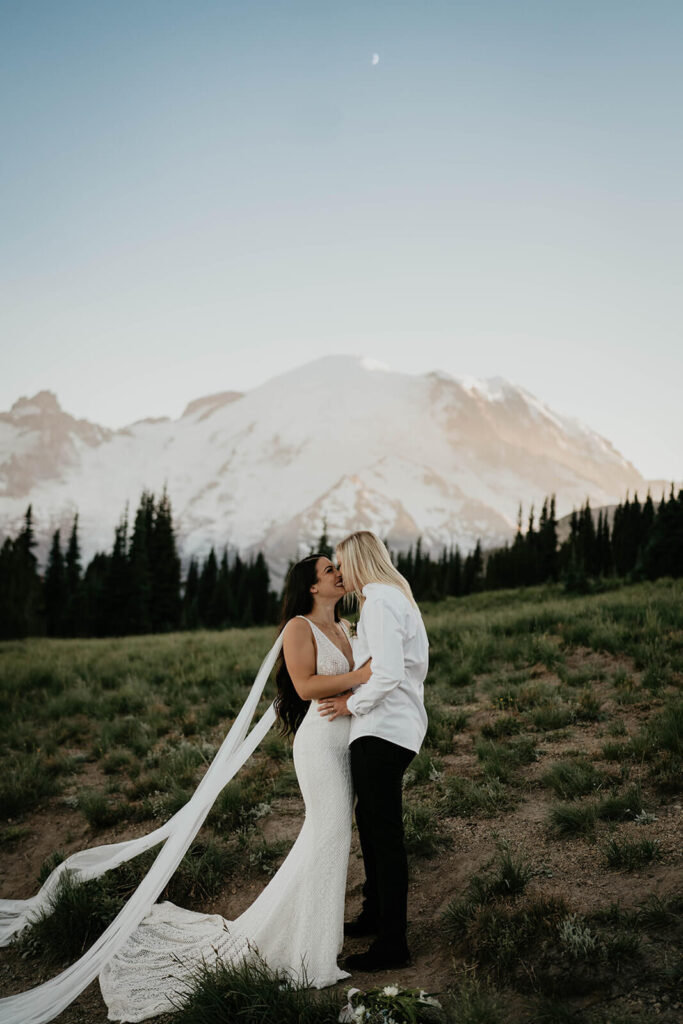 Two brides kissing during outdoor elopement at Mt Rainier