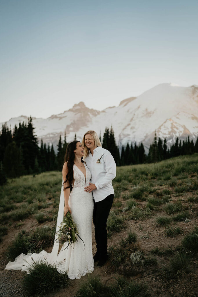 Two brides standing on a trail at Sunrise, Mt Rainier