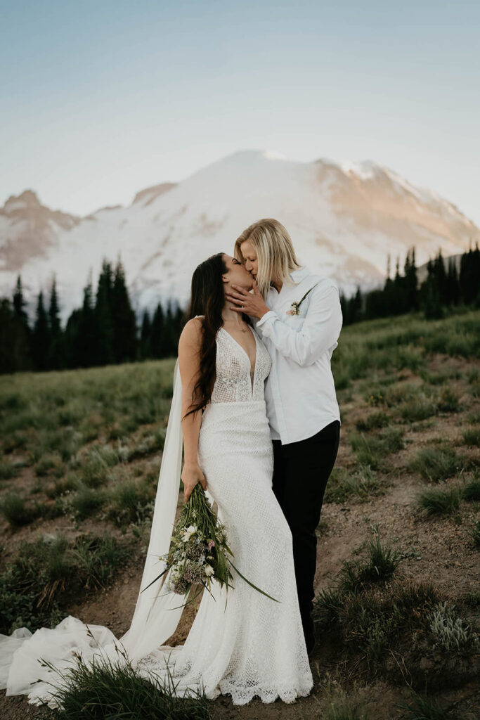 Two brides kissing after outdoor elopement at Mt Rainier