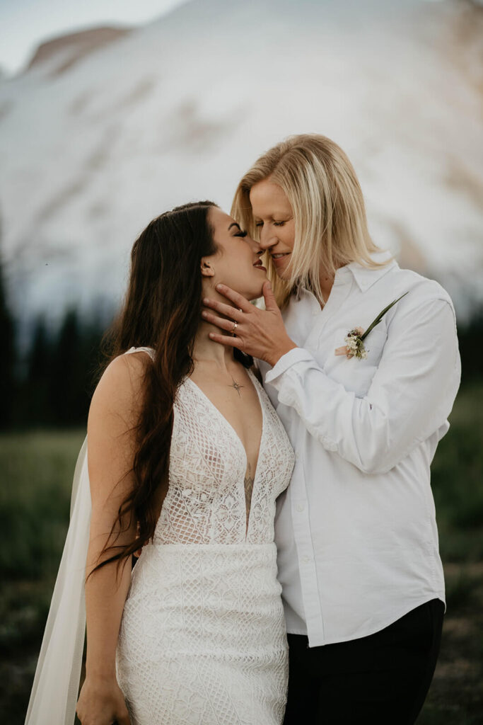 Two brides kissing after outdoor elopement at Mt Rainier