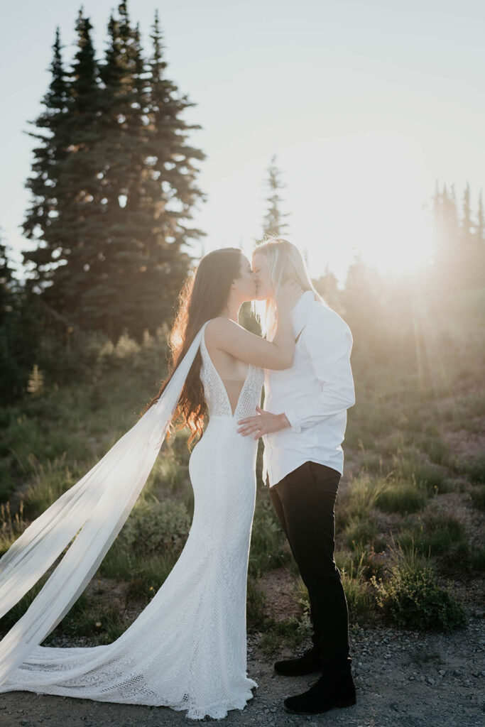 Two brides kissing during Sunrise, Mount Rainier elopement