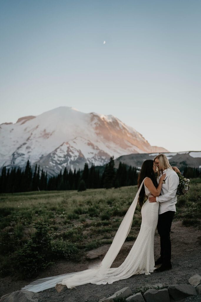 Two brides kiss during Sunrise, Mt Rainier elopement