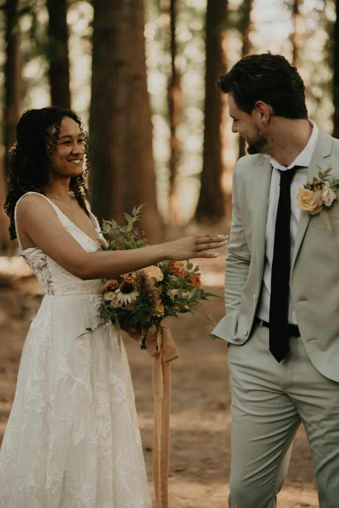 Bride and groom first look in the forest at CedarVale Events wedding