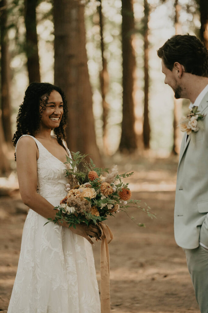 Bride and groom first look in the forest at CedarVale Events wedding