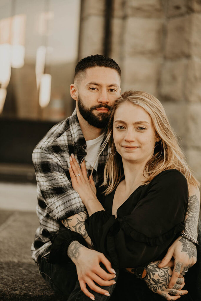 Couple sitting on the steps during engagement photo session in Portland