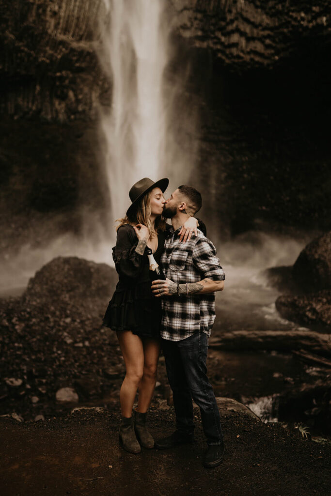 Couple kissing during adventure engagement session at Latourell Falls