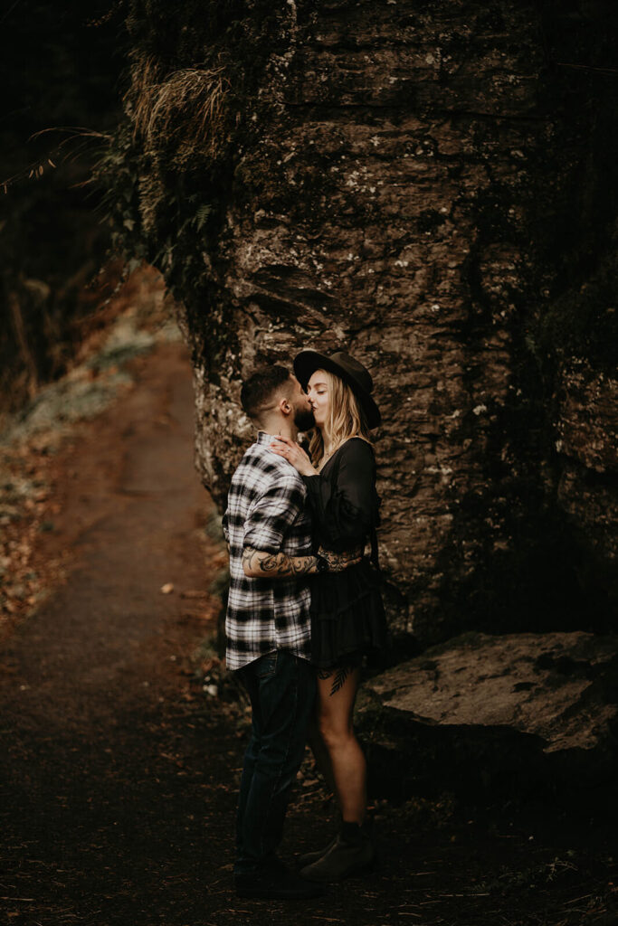 Couple kissing during adventure engagement session at Latourell Falls