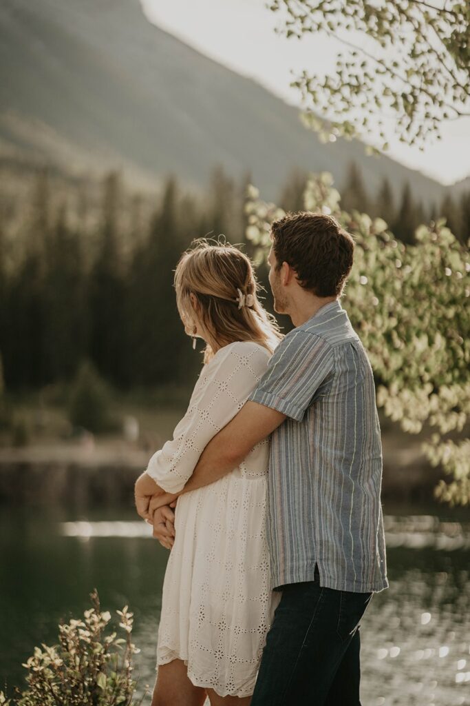 Man and woman hugging during outdoor engagement photoshoot in Banff