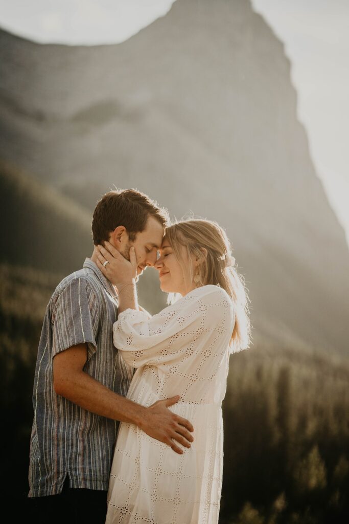Man and woman hugging during destination engagement photos session in Banff, Canada