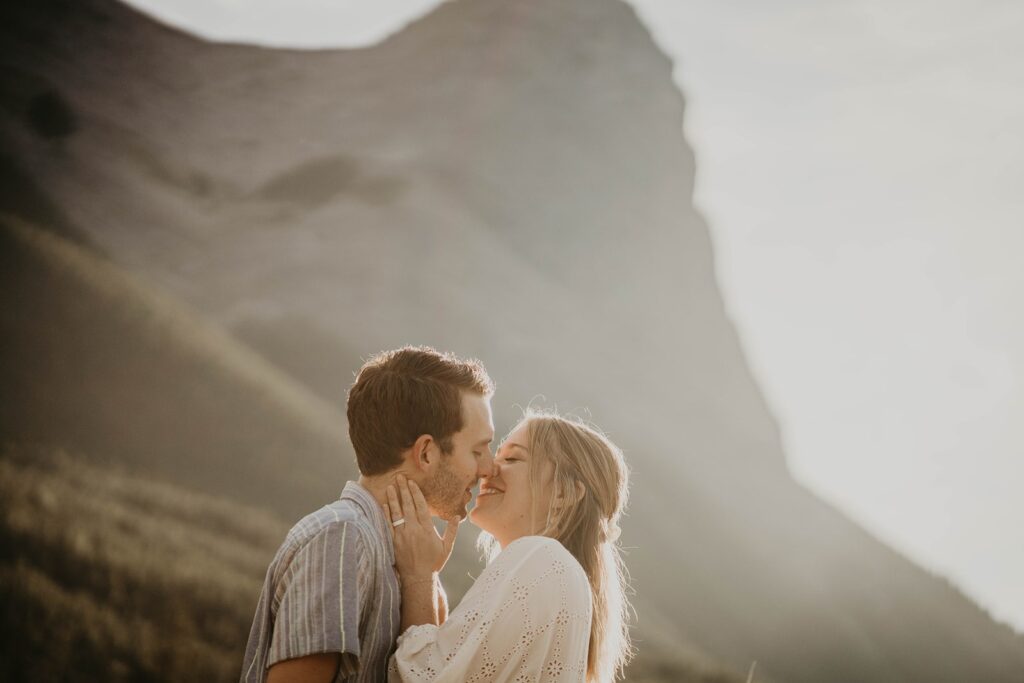 Man and woman kissing during destination engagement photos session in Banff, Canada