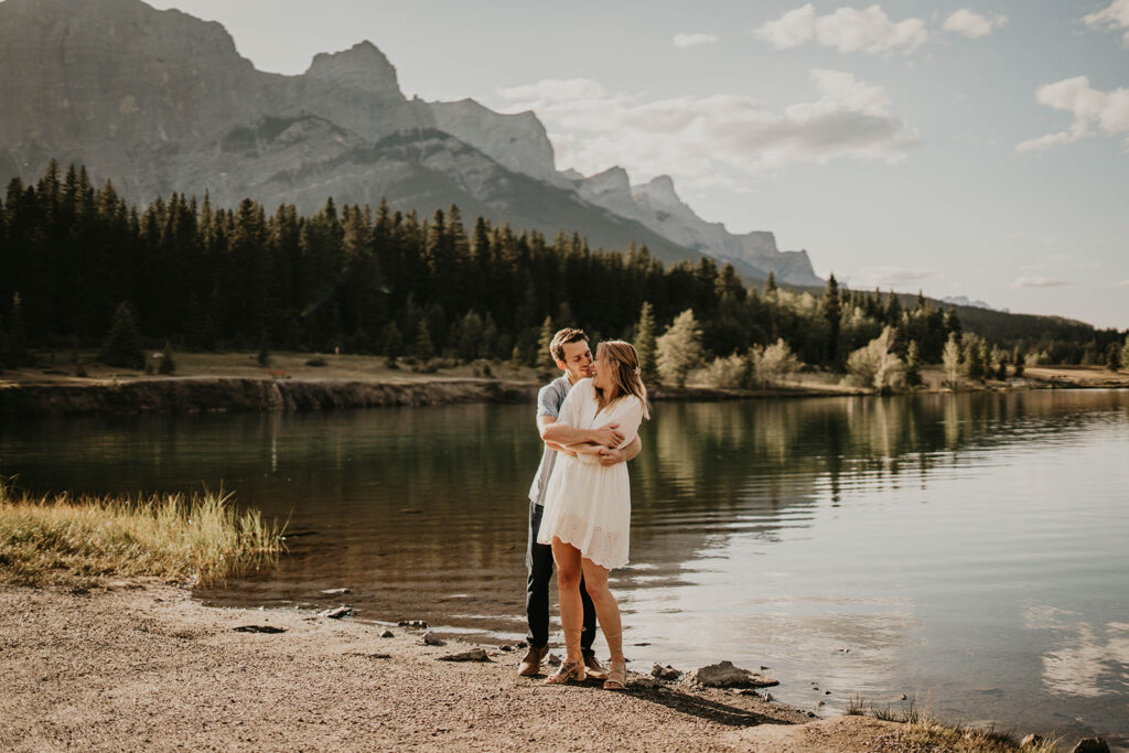 Couple hugging at Quarry Lake during adventure engagement photos in Banff