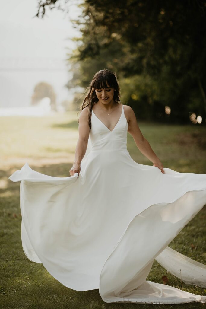 Bride twirling in her white crepe v-neck wedding dress from Brides for a Cause