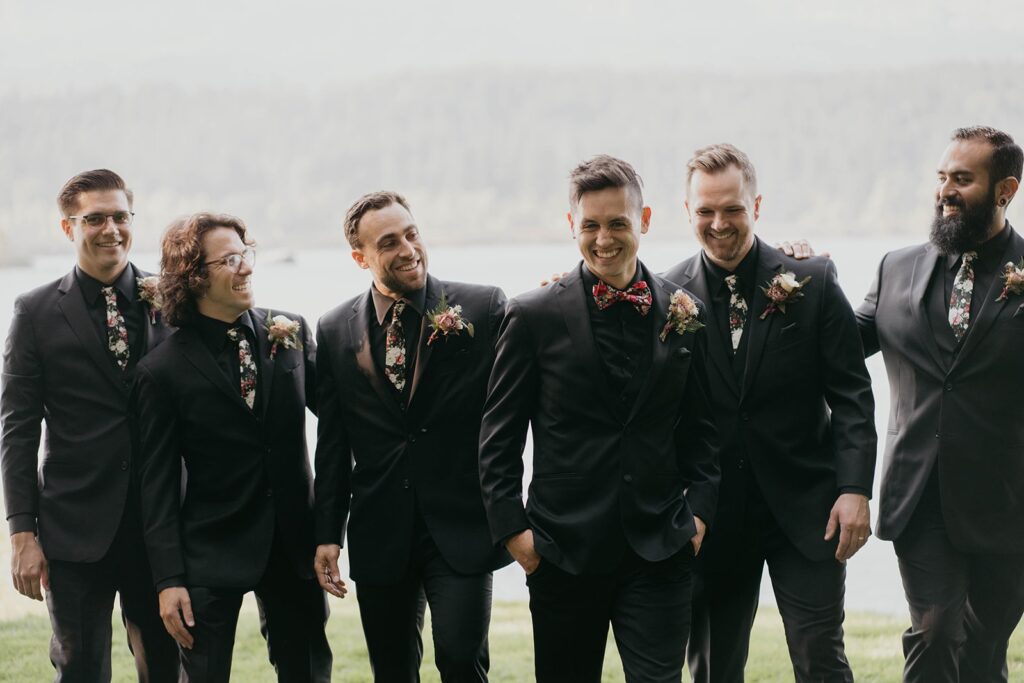 Wedding party photos by the Columbia River with groomsmen wearing all black suits