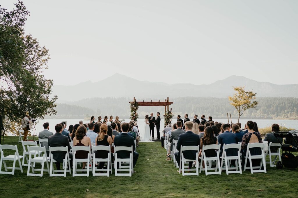Bride and groom standing at an outdoor wedding altar on the Columbia River
