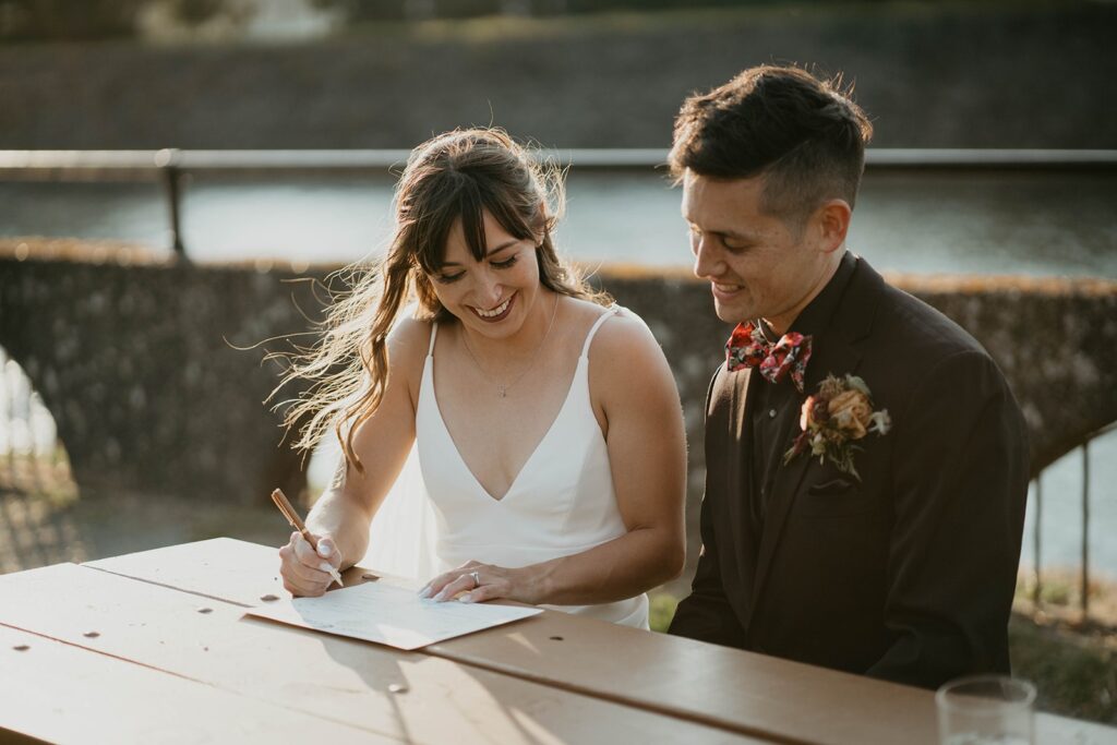 Bride and groom sign marriage license after their Cascade Locks wedding