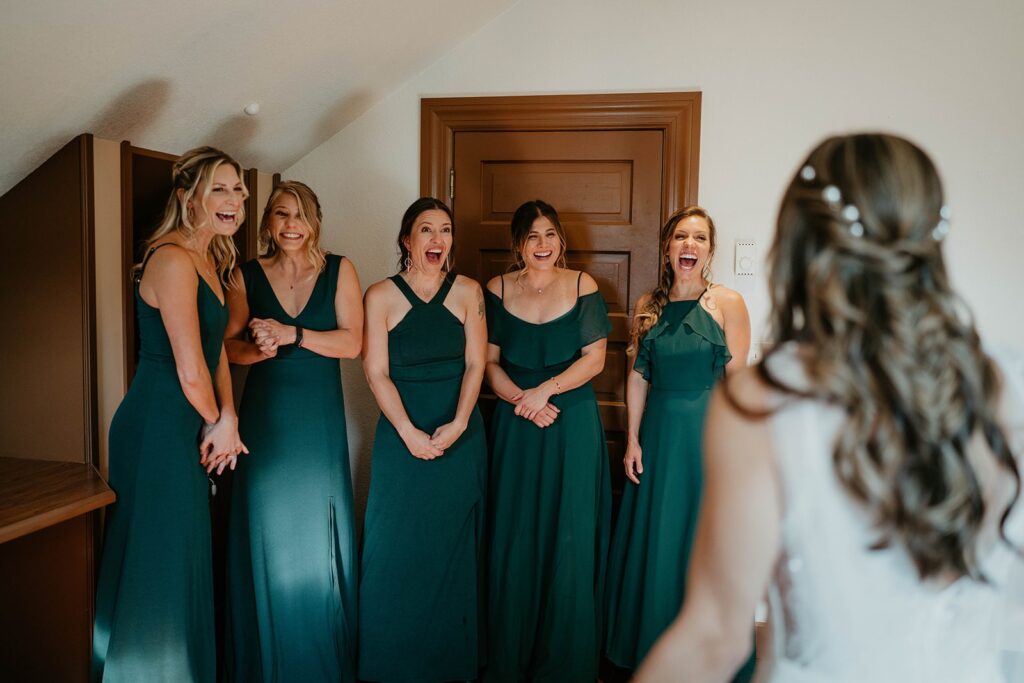 Bridesmaids reacting to first look with the bride
