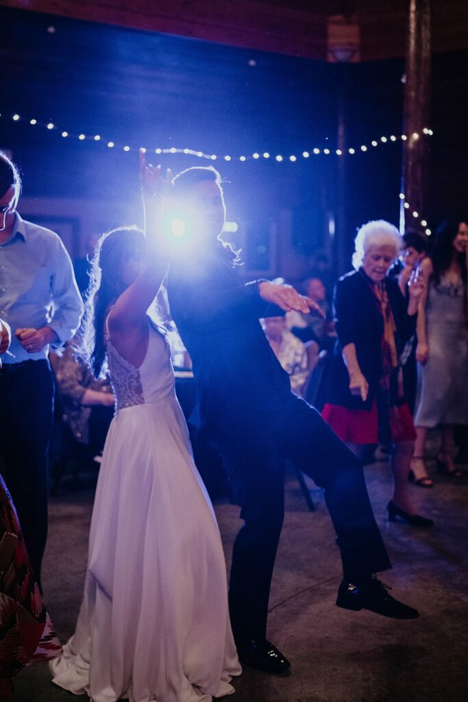 Bride and groom dancing with guests on the dance floor at their Cascade Locks wedding in Oregon