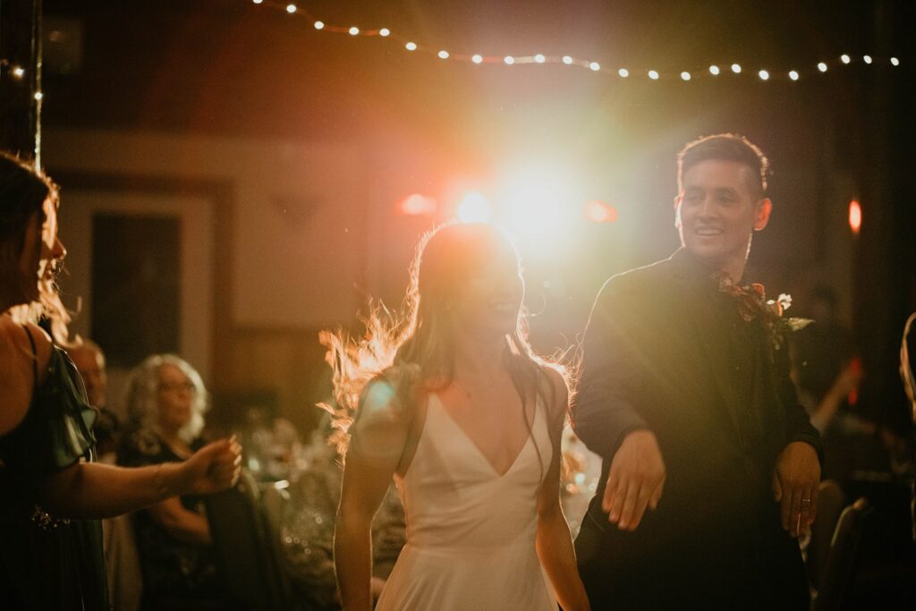 Bride and groom dancing with guests on the dance floor at their Cascade Locks wedding in Oregon