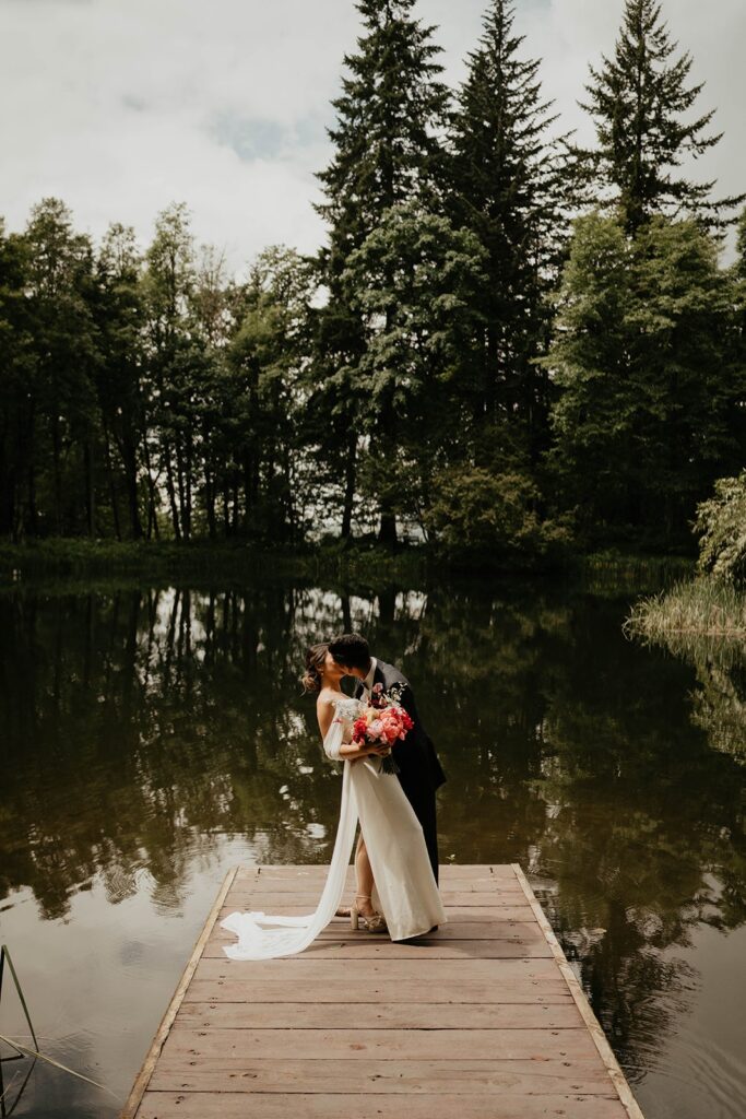 Bride and groom kiss by the lake at Bridal Veil Lakes