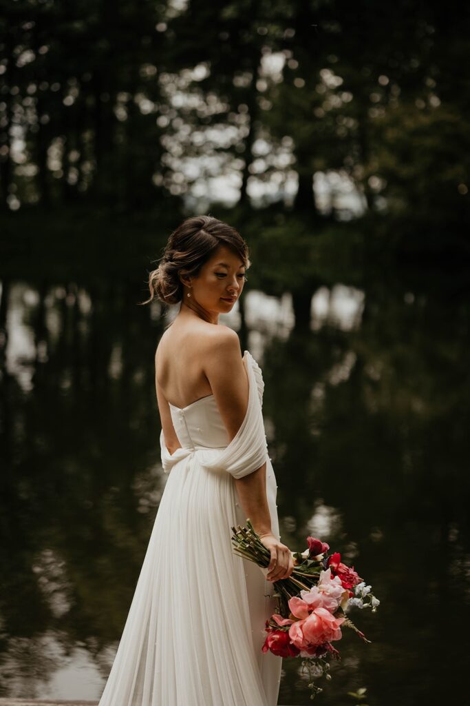 Bride standing by the lake during wedding portraits