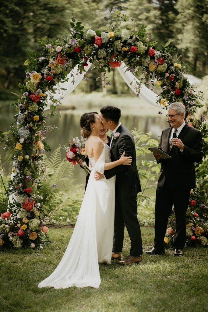 Bride and groom kiss during their modern Asian wedding at Bridal Veil Lakes