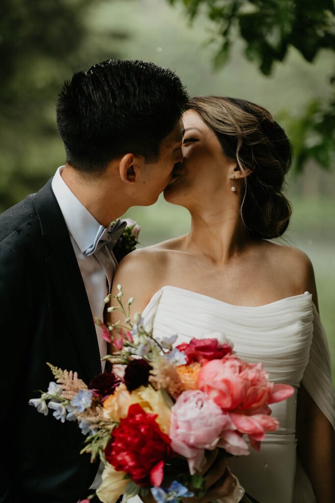 Bride and groom kiss during couple portraits at Bridal Veil Lakes wedding
