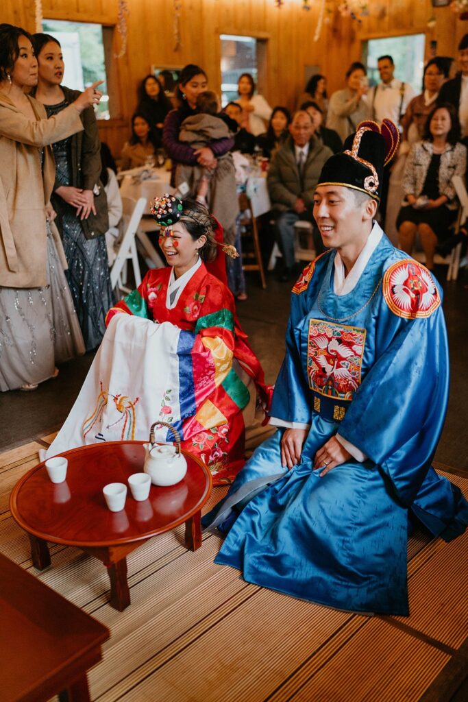 Bride and groom catch chestnuts during traditional Korean wedding ceremony