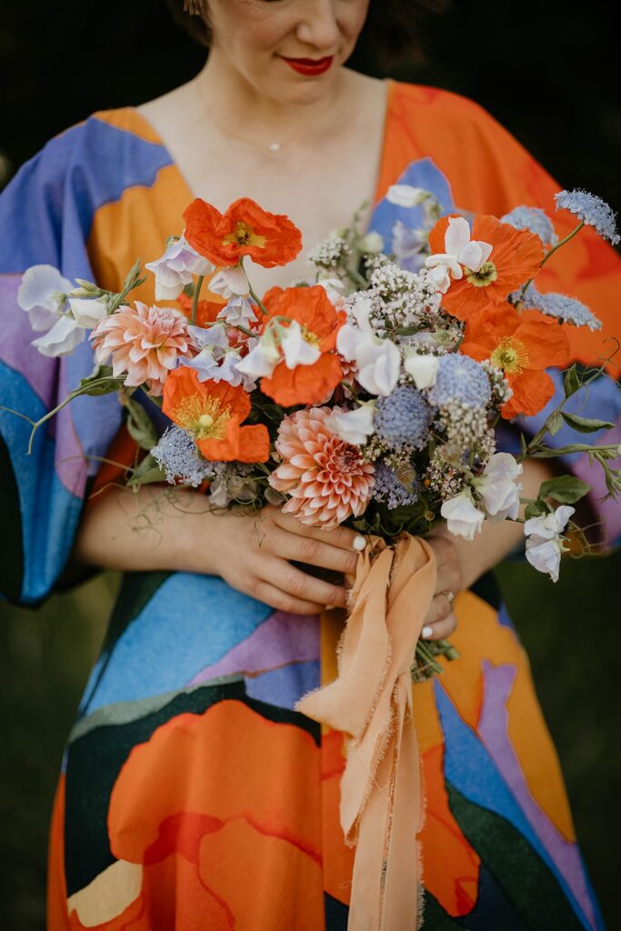 Bride wearing colorful wedding dress and colorful wedding flowers