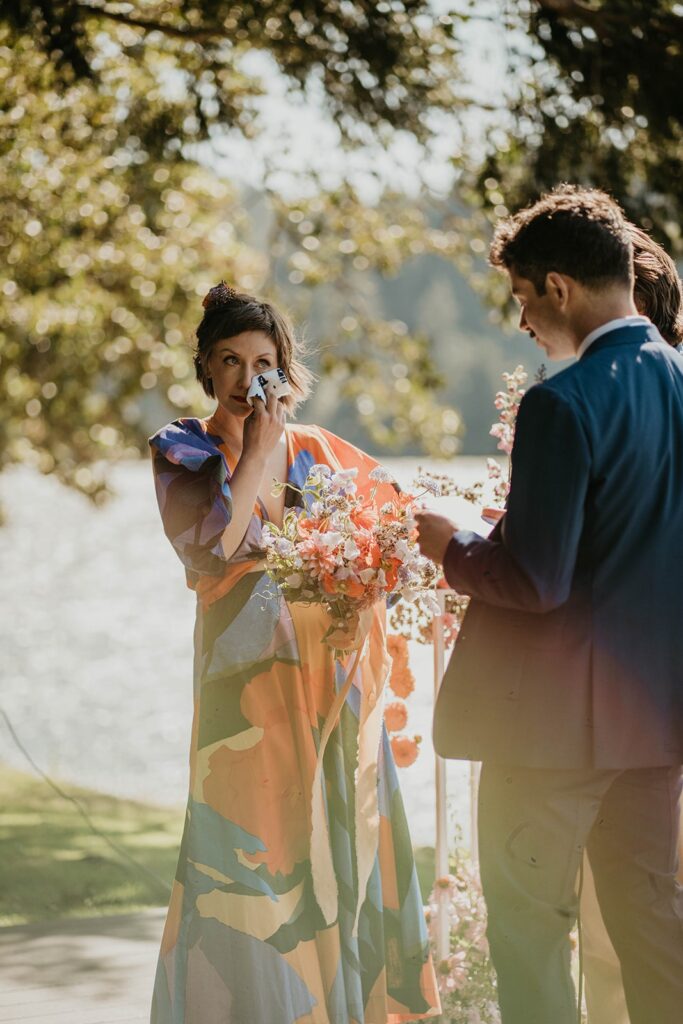 Bride wiping tears during outdoor wedding ceremony on Thunder Island