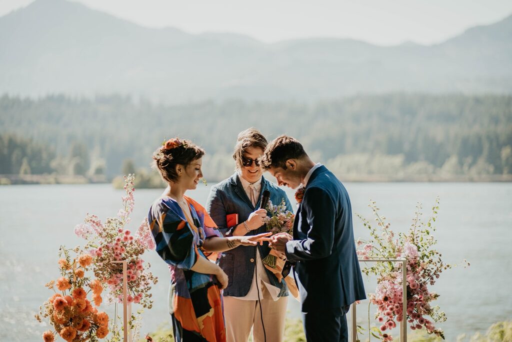 Bride and groom exchange rings during Cascade Locks wedding