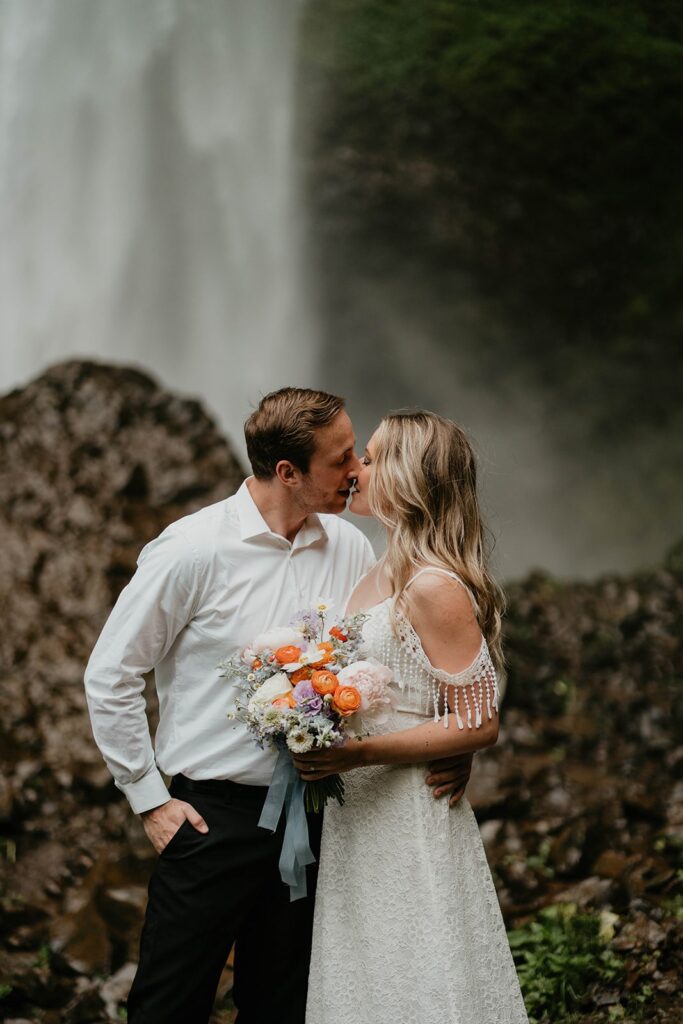 Bride and groom kiss at Latourell Falls elopement in Oregon