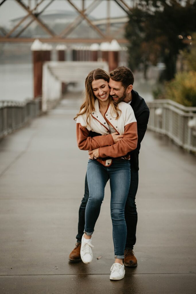 Couple hugging and laughing during engagement photos in Portland, Oregon