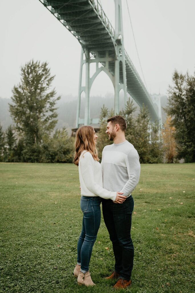Couple holding hands during fall engagement photos in downtown Portland