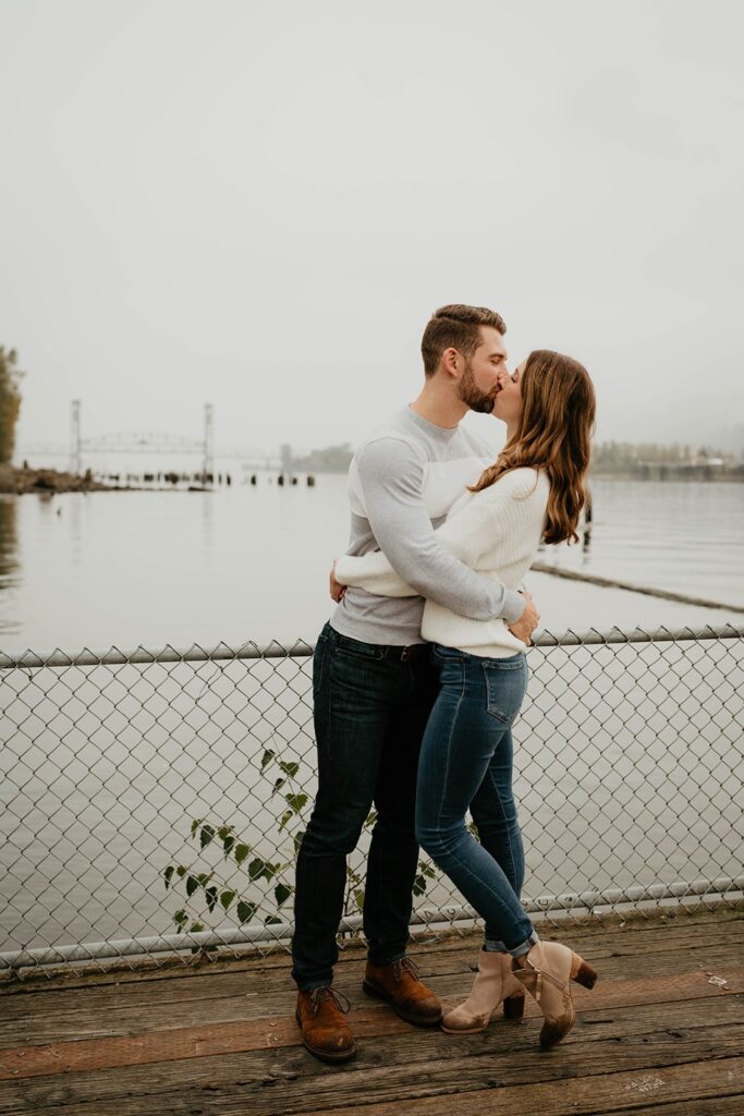 Couple kissing at one of the best places for engagement photos in Oregon: Cathedral Park