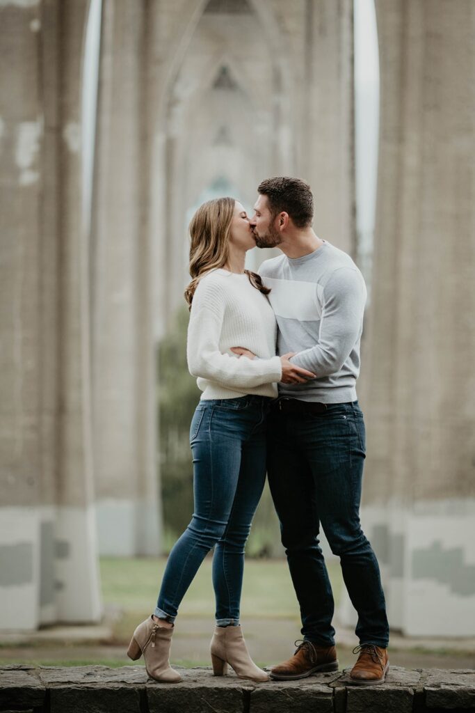 Couple kisses during fall engagement session in downtown Portland, Oregon
