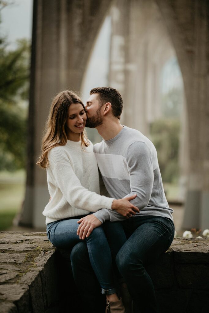 Couple kissing during fall engagement photos in Portland, Oregon