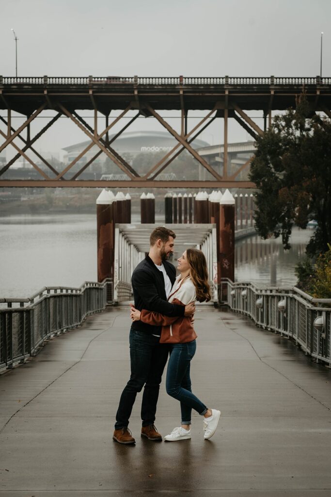 Couple hugging during their fall engagement photo session in Portland, Oregon