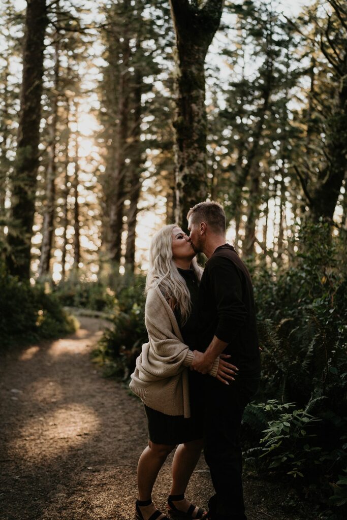 Couple kissing in the forest during their Oregon engagement session