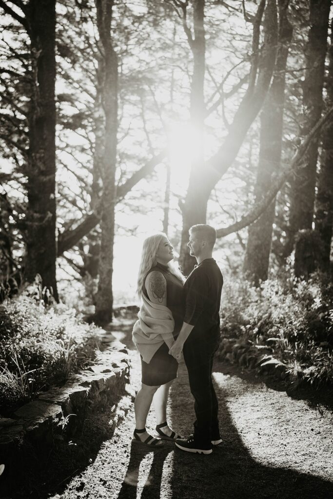 Couple holding hands while standing on a forest trail at Cape Perpetua