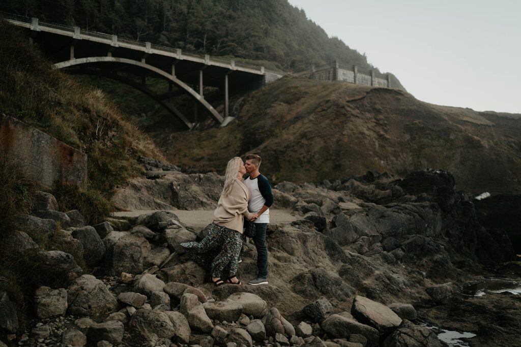 Couple kissing on the rocks during their Oregon Coast engagement photos at Thor's Well.