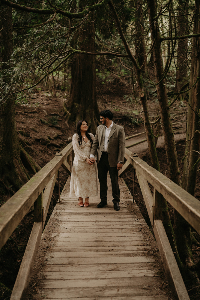 A couple sharing lovingly into each other's eyes on a bridge in Hoyt Arboretum. 