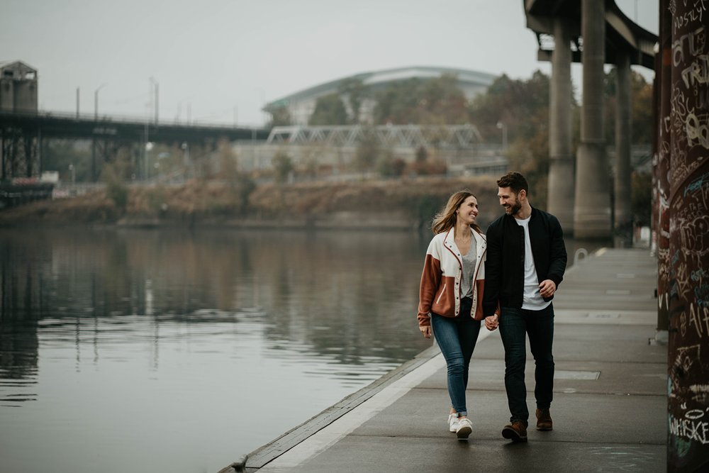 A couple walking along the Willamette River waterfront in downtown Portland. 