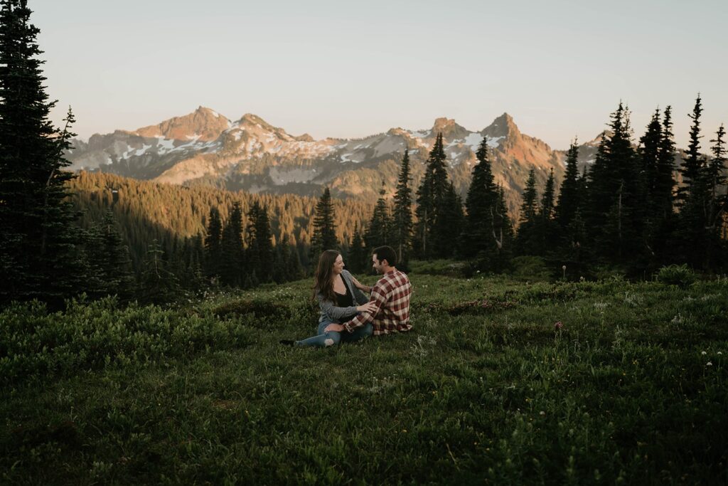 Couple sitting in the field at their Mt Rainier engagement photos session