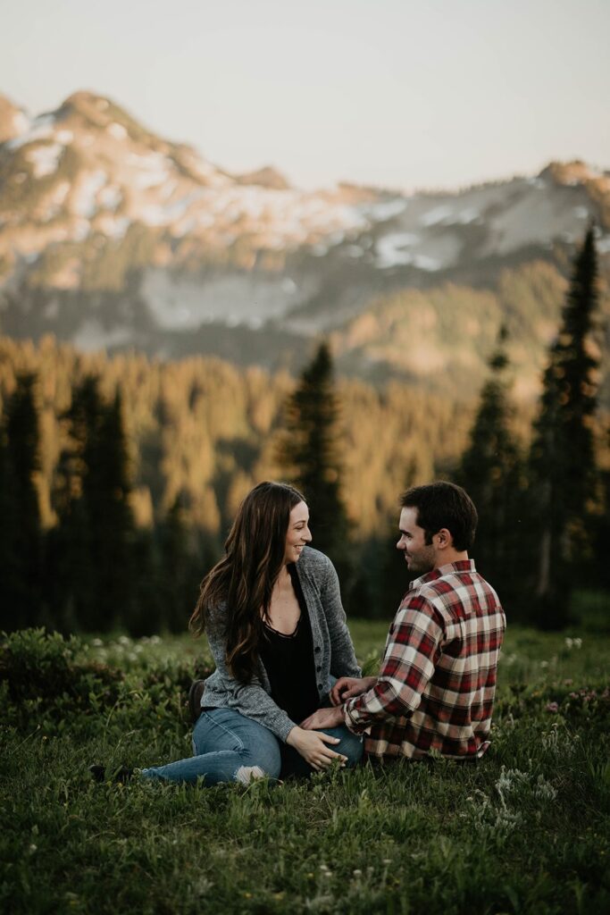 Couple laughing in the grass during Mt Rainier engagement photos