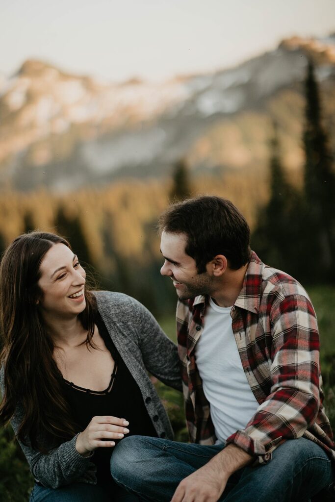 Couple laughing during hiking engagement photos at Mt Rainier