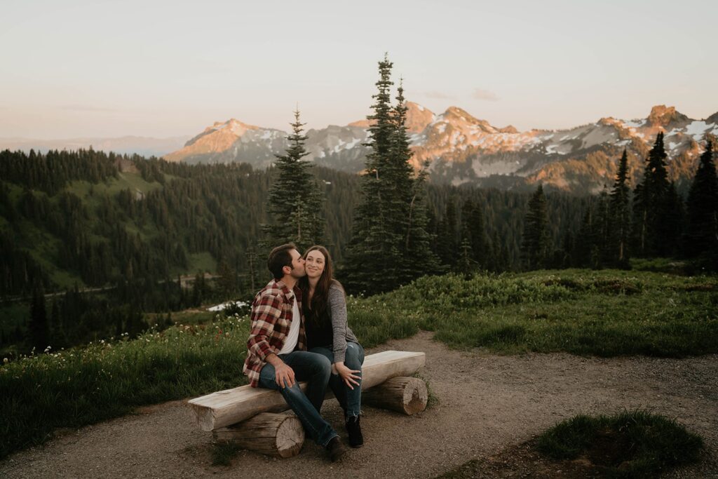 Couple sitting on a bench at sunset during Mt Rainier engagement photos