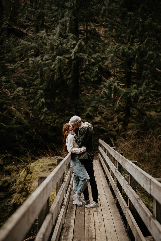 A couple kissing on a bridge at the Columbia River Gorge. 