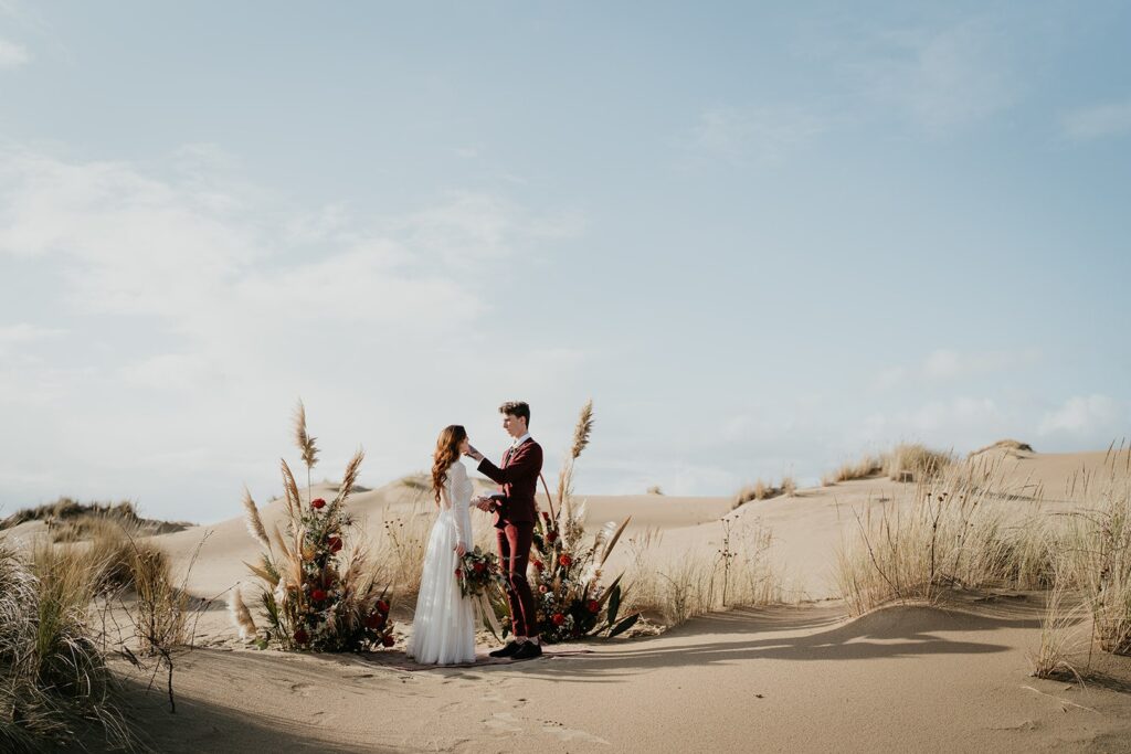 Bride and groom exchange handwritten vows during their Oregon sand dunes elopement ceremony